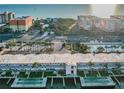 Aerial view of condo complex with pool and shuffleboard at 18399 Gulf Blvd # 372, Indian Shores, FL 33785