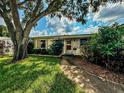 Charming single story home with mature landscaping and walkway at 6087 16Th Ne Ln, St Petersburg, FL 33703