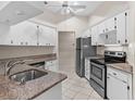 Kitchen with granite countertops and stainless steel appliances at 3856 Goldfinch Ct, Palm Harbor, FL 34685