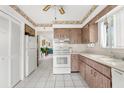 View of kitchen with white appliances and wood cabinets at 4445 Pelorus Dr, New Port Richey, FL 34652