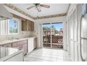 Cozy kitchen featuring wood cabinets and access to a balcony at 4445 Pelorus Dr, New Port Richey, FL 34652