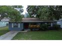 House exterior, blue siding, red door, and landscaping at 12889 126Th St, Largo, FL 33774