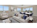Bright living room features a comfortable sofa and marble dining table at 6075 Shore S Blvd # 501, Gulfport, FL 33707