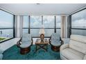 Living room with water view and comfortable seating at 300 Woodette Dr # 202B, Dunedin, FL 34698