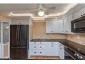Kitchen with white cabinets, granite countertops, and stainless steel appliances at 100 Bluff View Dr # 208B, Belleair Bluffs, FL 33770