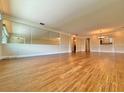 Spacious living room with hardwood floors and large windows at 100 Bluff View Dr # 208B, Belleair Bluffs, FL 33770