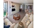 Bright living room featuring built-in shelving, wood floors, comfortable seating, and an adjacent dining area at 6268 Palma Del Mar S Blvd # 407, St Petersburg, FL 33715