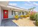 Inviting house exterior featuring a red door and well-manicured landscaping at 4145 Star Island Dr, Holiday, FL 34691