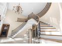 Elegant double staircase with ornate railings in a large foyer at 2901 Leprechaun Ln, Palm Harbor, FL 34683