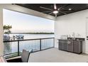 Enjoy this expansive patio with outdoor kitchen, ceiling fan, and views of the beautiful waterfront at 2121 Bayou Grande Ne Blvd, St Petersburg, FL 33703
