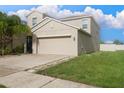 Two-story house with attached garage, driveway, and landscaping at 105 Cascade Bend Dr, Ruskin, FL 33570
