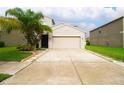 Two-story house with attached garage and well-maintained lawn at 105 Cascade Bend Dr, Ruskin, FL 33570