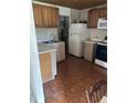Kitchen with wood cabinets, double sink, and appliances at 2317 8Th E Ave, Bradenton, FL 34208