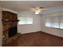 Spacious living room with hardwood floors and a stone fireplace at 824 62Nd Ne Ave, St Petersburg, FL 33702
