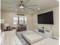Living room with sectional sofa, large TV, and electric fireplace at 5245 Amulet Dr # 306, New Port Richey, FL 34652