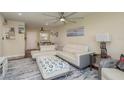 Living room with sectional sofa, ottoman, and dining area view at 5245 Amulet Dr # 306, New Port Richey, FL 34652