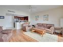 Living room with hardwood floors and kitchen view at 880 Mandalay Ave # C713, Clearwater Beach, FL 33767