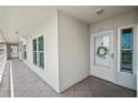 Condo hallway with white door and wreath at 5701 Bahia Del Mar Cir # 507, St Petersburg, FL 33715