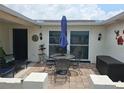 Outdoor patio with seating area, umbrella, and brick flooring at 1172 Chelsea Ln, Holiday, FL 34691