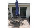 Outdoor patio with seating area and umbrella at 1172 Chelsea Ln, Holiday, FL 34691