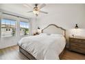 Main bedroom with king bed and ceiling fan at 21811 Lyonia Ln, Land O Lakes, FL 34637