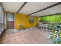 Screened patio with tile flooring and seating area at 7313 S Obrien St, Tampa, FL 33616