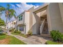 View of the side of a two-story condo building with stairs leading to a unit at 6141 Bahia Del Mar Blvd # 232, St Petersburg, FL 33715