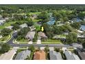 Aerial view of a single Gathering home with a pond in the background at 3623 Doral St, Palm Harbor, FL 34685