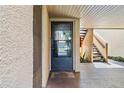 Private condo entry with screen door and nearby stairs at 750 N Village N Dr # 106, St Petersburg, FL 33716