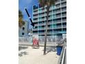 Exterior view of beachfront hotel with palm trees at 10650 Gulf Blvd # 340, Treasure Island, FL 33706