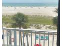 Stunning ocean view from condo balcony, showing beach and chairs at 10650 Gulf Blvd # 340, Treasure Island, FL 33706