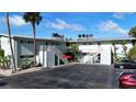 Exterior view of condo building with parking and lush landscaping at 2570 Gary Cir # 3, Dunedin, FL 34698