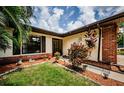 Side view of the house, highlighting landscaping and entryway at 2014 Montego Ct, Oldsmar, FL 34677