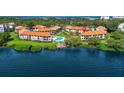 Aerial view of waterfront community with pool and dock at 1515 Pinellas Bayway S # 65, St Petersburg, FL 33715