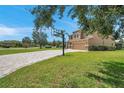 House exterior with basketball court and paver driveway at 116 Caladium Ct, Bradenton, FL 34212