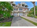 Two story townhome with attached garage and lush landscaping at 4654 Mirabella Ct, St Pete Beach, FL 33706