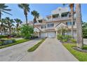 Two story townhome with attached garage and lush landscaping at 4654 Mirabella Ct, St Pete Beach, FL 33706