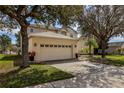 Two-car garage with driveway and landscaping at 8556 Southern Charm Cir, Brooksville, FL 34613