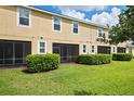 Townhouse backyard with screened patio and lawn at 2505 Arch Ave, Oldsmar, FL 34677