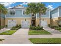 Townhouse exterior with two-car garage and landscaping at 2505 Arch Ave, Oldsmar, FL 34677