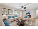 Light and airy living room with beige sofa and wood-look floors at 1618 Valencia St, Clearwater, FL 33756