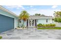 House exterior with a welcoming entrance and landscaping at 5690 Bayview Dr, Seminole, FL 33772