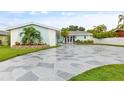 Stunning home exterior with a stone driveway and landscaping at 5690 Bayview Dr, Seminole, FL 33772