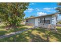 Ranch style home with stone accents and a landscaped yard at 751 90Th N Ave, St Petersburg, FL 33702
