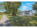 Ranch style home with stone accents and a landscaped yard at 751 90Th N Ave, St Petersburg, FL 33702