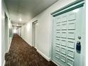 Building hallway with carpet flooring and light-colored walls at 2700 Bayshore Blvd # 3212, Dunedin, FL 34698