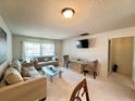 Living room with sofa, dining table and access to kitchen at 2700 Bayshore Blvd # 3212, Dunedin, FL 34698