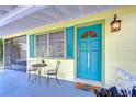Charming porch with blue door, seating, and ample natural light, creating a welcoming entrance to the home at 5210 Newton S Ave, Gulfport, FL 33707