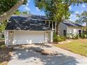 Attached two-car garage with a wide driveway, offering plenty of parking at 5841 Bay Pines Lakes Blvd, St Petersburg, FL 33708
