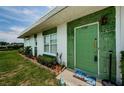 Inviting front entrance with a decorative green door and well-manicured landscaping at 7787 39Th N Ter # 7787, St Petersburg, FL 33709